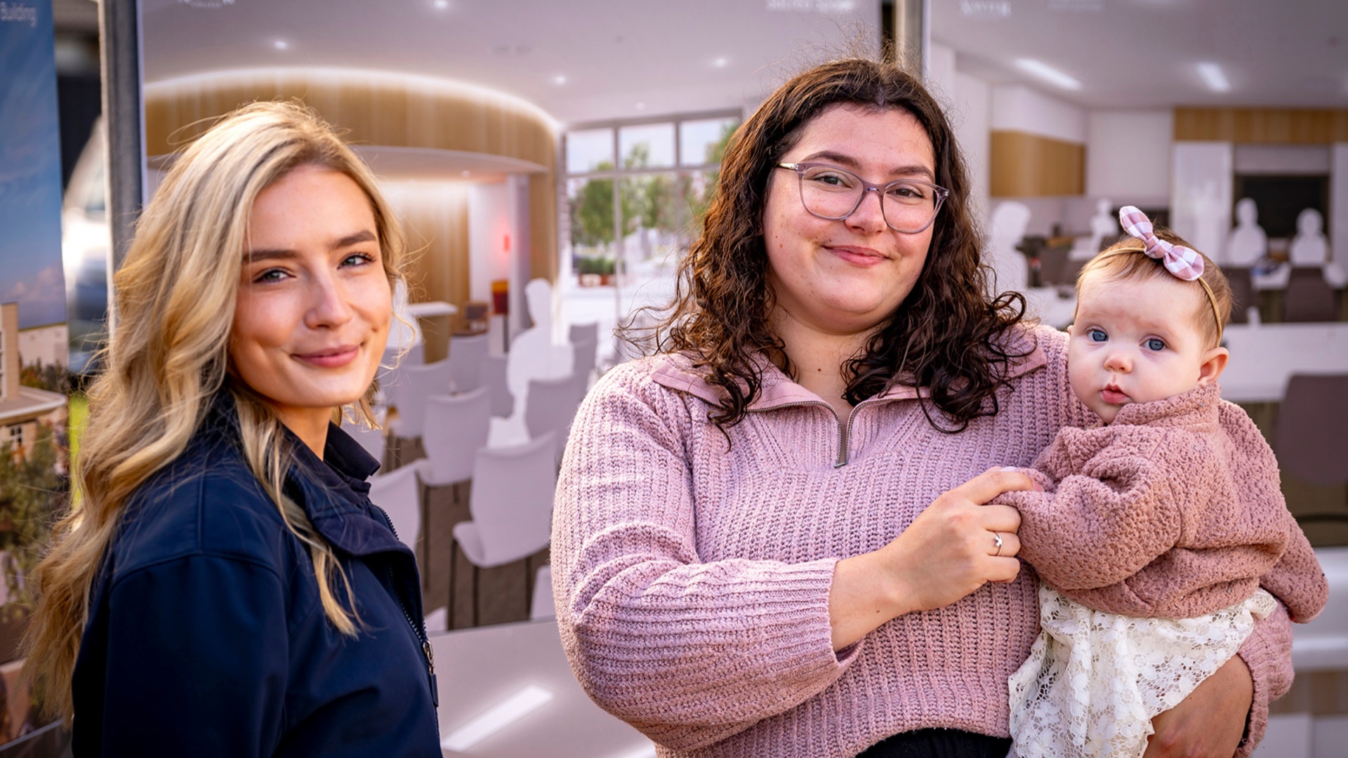 A mum with her child with a staff member at Riverlea