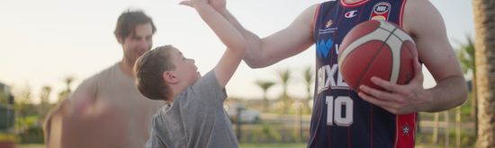 Adelaide 36ers Basketball player high-fiving someone