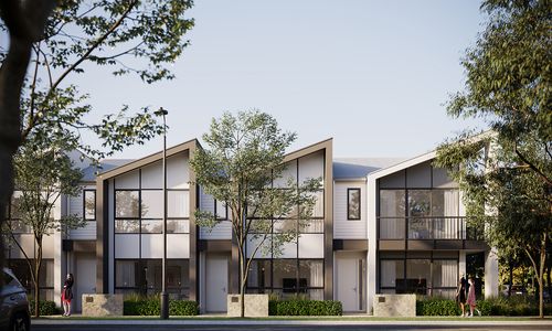 A row of modern townhomes at Riverlea along a quiet street on a bright, clear day.