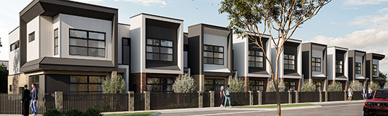A row of modern townhomes at Riverlea along a quiet street on a bright, clear day.