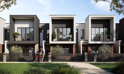A row of modern townhomes at Riverlea along a quiet street on a bright, clear day with two people walking on footpath.
