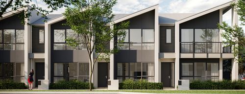 A row of modern townhomes at Riverlea along a quiet street on a bright, clear day.